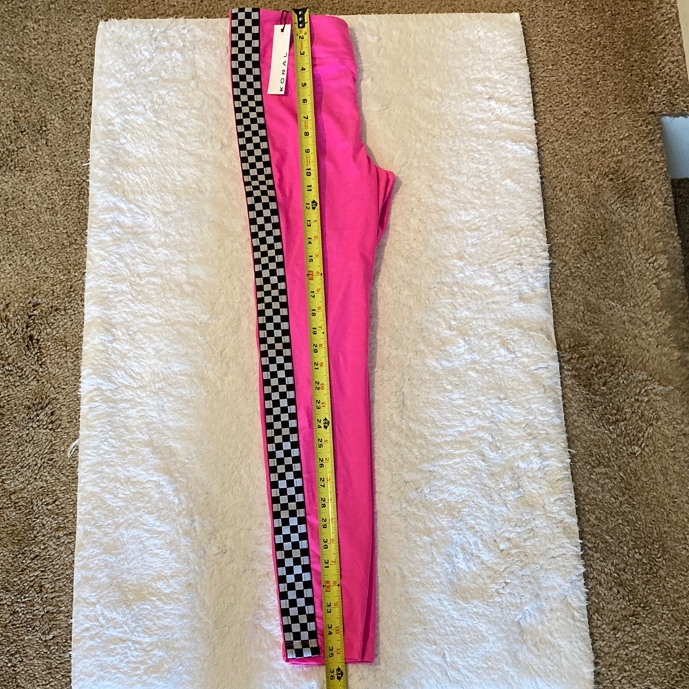 Koral Hot Pink Leggings with Black-and-White Checkered Side Stripes.